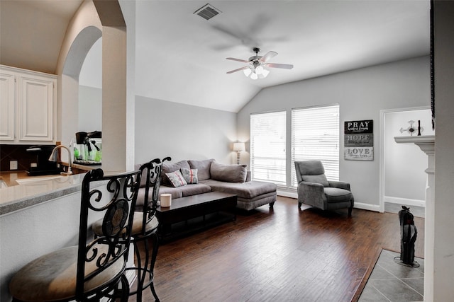 26622 Clear Mill Ln, Katy, TX 77494 - living room featuring ceiling fan, lofted ceiling, dark wood-style flooring, arched walkways, and baseboards