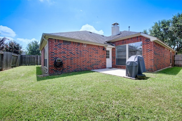 26622 Clear Mill Ln, Katy, TX 77494 - back of property with brick siding, a chimney, a patio area, and roof with shingles