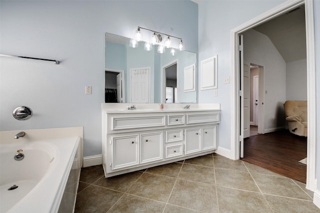 26622 Clear Mill Ln, Katy, TX 77494 - full bathroom with double vanity, tile patterned floors, a bath, and baseboards