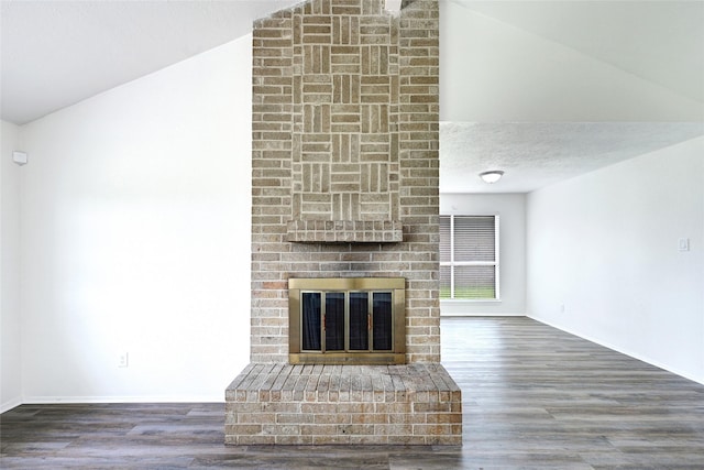 1323 Fieldstone, Missouri City, TX 77489 - unfurnished living room with lofted ceiling, a fireplace, wood finished floors, and baseboards