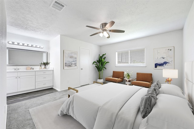 1323 Fieldstone, Missouri City, TX 77489 - carpeted bedroom with a textured ceiling, ceiling fan, a sink, and baseboards