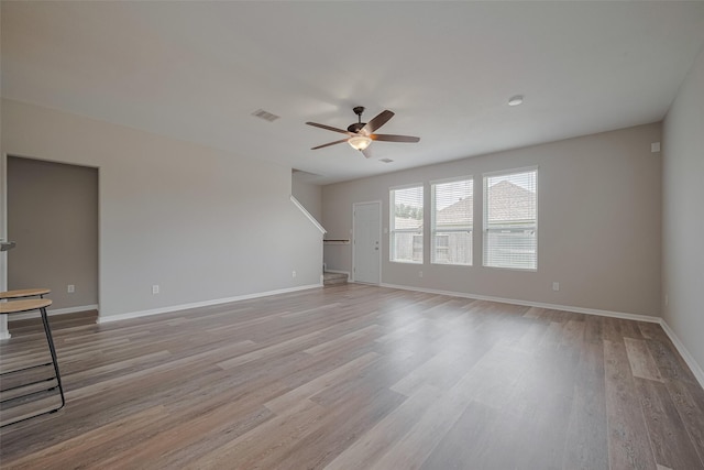 2810 Meadowbrook Ln, Rosenberg, TX 77471 - unfurnished living room with a ceiling fan, light wood-style flooring, and baseboards