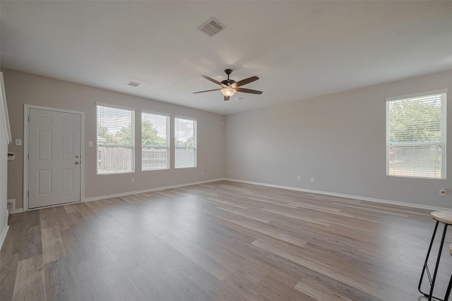 2810 Meadowbrook Ln, Rosenberg, TX 77471 - spare room with a ceiling fan, light wood finished floors, healthy amount of natural light, and baseboards