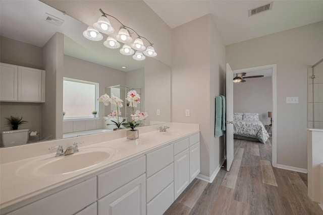 2810 Meadowbrook Ln, Rosenberg, TX 77471 - ensuite bathroom featuring double vanity, wood finished floors, a shower, and ceiling fan