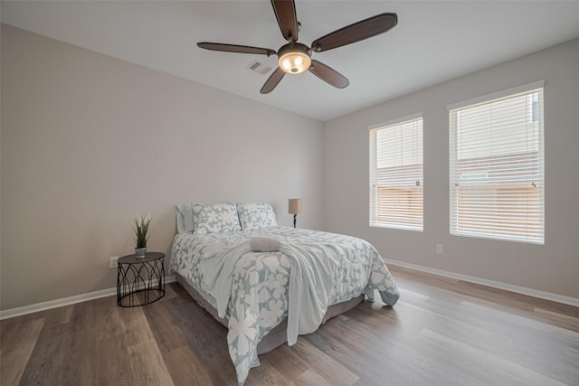 2810 Meadowbrook Ln, Rosenberg, TX 77471 - bedroom featuring multiple windows, light wood-style flooring, and baseboards