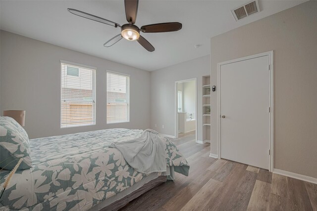2810 Meadowbrook Ln, Rosenberg, TX 77471 - bedroom with wood finished floors, baseboards, ceiling fan, and ensuite bathroom