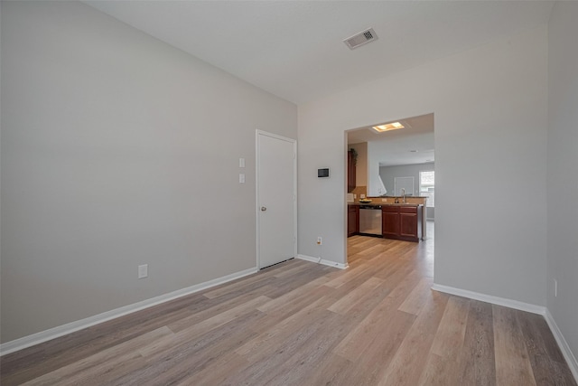 2810 Meadowbrook Ln, Rosenberg, TX 77471 - spare room with a sink, light wood-style flooring, and baseboards