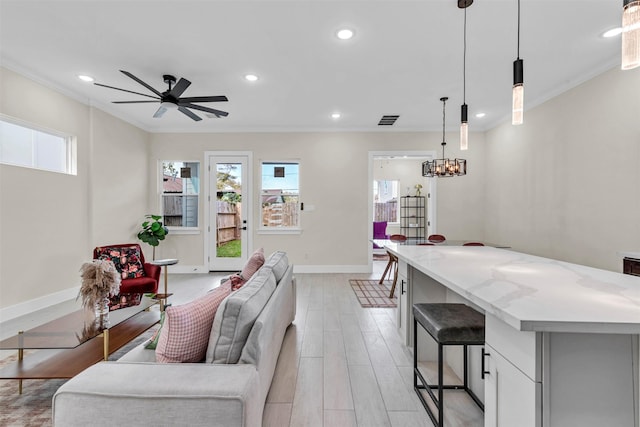 4908 Broom St, Houston, TX 77091 - living area with ornamental molding, baseboards, light wood-type flooring, ceiling fan, and recessed lighting