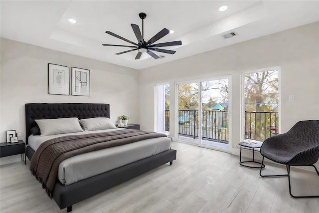 4908 Broom St, Houston, TX 77091 - bedroom with a tray ceiling, access to outside, multiple windows, light wood-style flooring, and recessed lighting