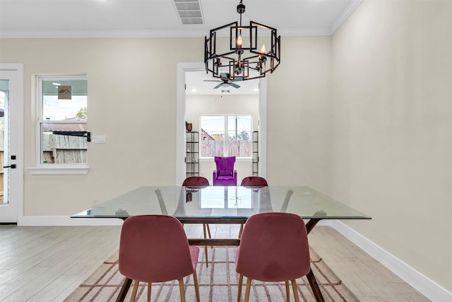 4908 Broom St, Houston, TX 77091 - dining room with a chandelier, wood finished floors, ornamental molding, and baseboards