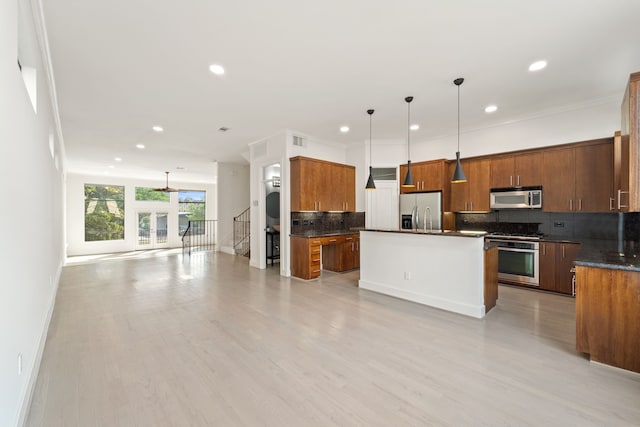 6217 Westcott St Unit B, Houston, TX 77007 - kitchen featuring stainless steel appliances, tasteful backsplash, a kitchen island, brown cabinetry, and open floor plan