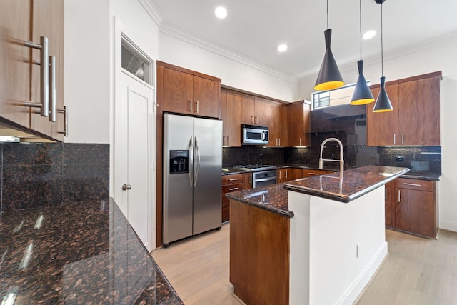 6217 Westcott St Unit B, Houston, TX 77007 - kitchen featuring appliances with stainless steel finishes, crown molding, tasteful backsplash, light wood-type flooring, and pendant lighting