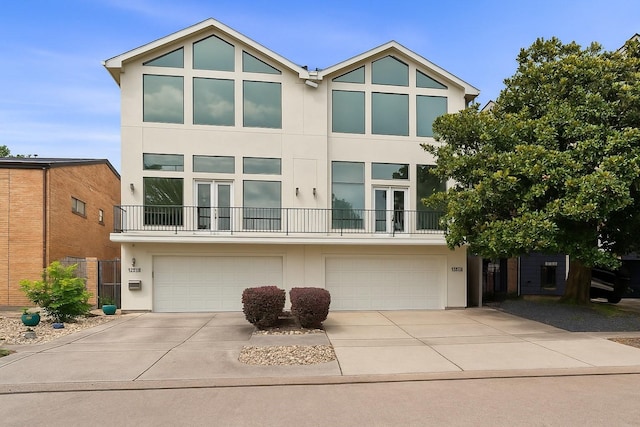 6217 Westcott St Unit B, Houston, TX 77007 - view of front of property with french doors, stucco siding, and a garage