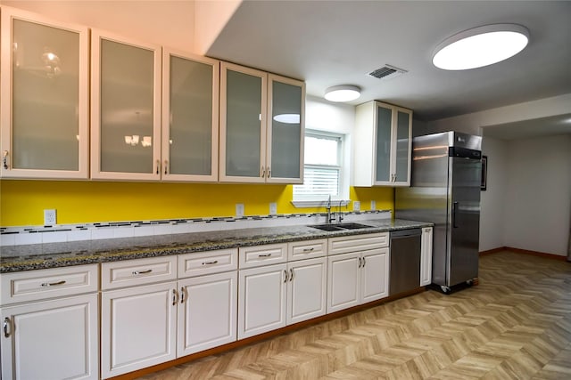 2106 Silver Falls Dr, Houston, TX 77339 - kitchen with a sink, dishwasher, freestanding refrigerator, and white cabinetry