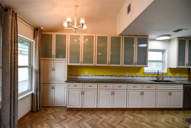 2106 Silver Falls Dr, Houston, TX 77339 - kitchen featuring a sink, a chandelier, white cabinets, dark stone countertops, and lofted ceiling