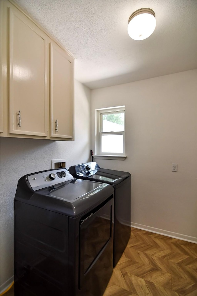 2106 Silver Falls Dr, Houston, TX 77339 - laundry area with cabinet space, independent washer and dryer, and a textured ceiling