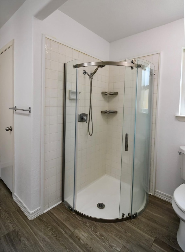 2106 Silver Falls Dr, Houston, TX 77339 - full bathroom with wood finished floors, toilet, a shower stall, and baseboards