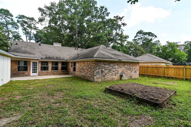 2106 Silver Falls Dr, Houston, TX 77339 - rear view of house with a patio, a chimney, and brick siding