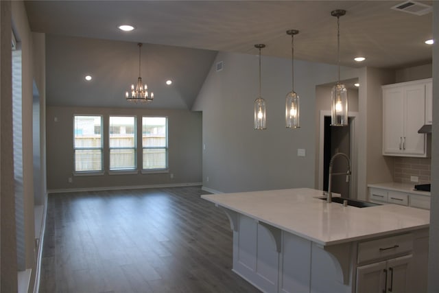 143 Nightshade St, Richmond, TX 77406 - kitchen with a sink, a chandelier, white cabinets, light countertops, and wood finished floors