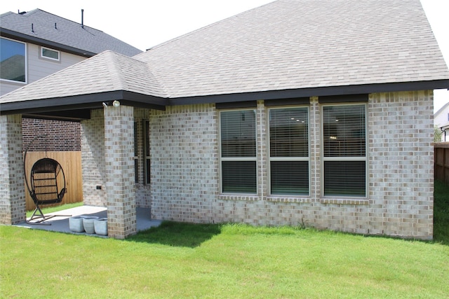 143 Nightshade St, Richmond, TX 77406 - back of house with brick siding, a lawn, a patio area, and roof with shingles