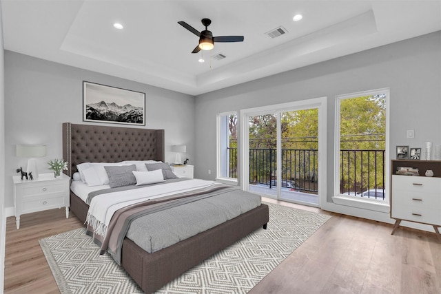 5029 Creekmont Dr, Houston, TX 77091 - bedroom featuring a tray ceiling, access to outside, wood finished floors, recessed lighting, and ceiling fan