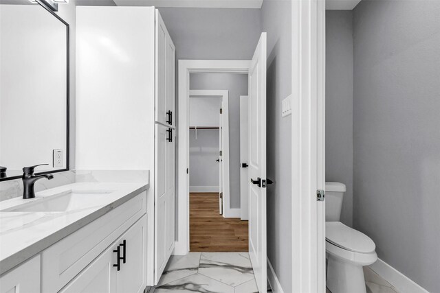 5029 Creekmont Dr, Houston, TX 77091 - bathroom featuring vanity, baseboards, toilet, and marble finish flooring
