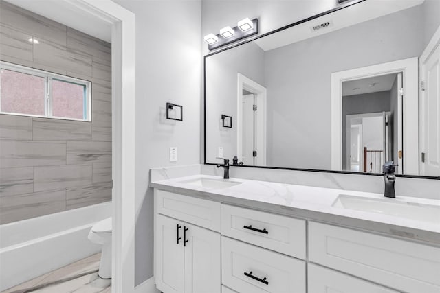 5029 Creekmont Dr, Houston, TX 77091 - bathroom with marble finish flooring, double vanity, toilet, and bathing tub / shower combination