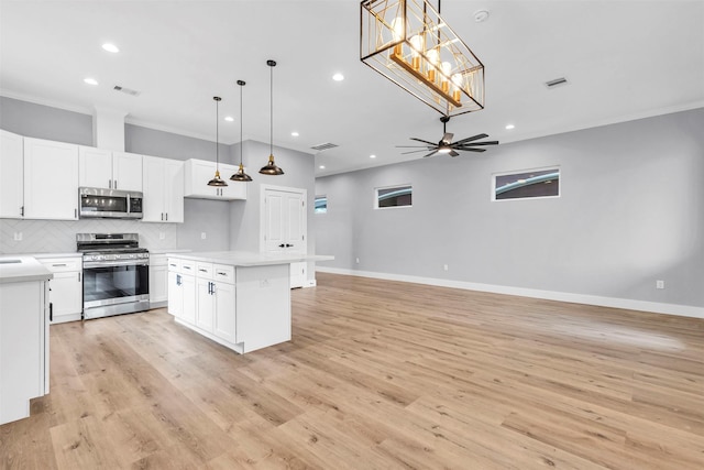 5029 Creekmont Dr, Houston, TX 77091 - kitchen featuring stainless steel appliances, ornamental molding, backsplash, light countertops, and open floor plan