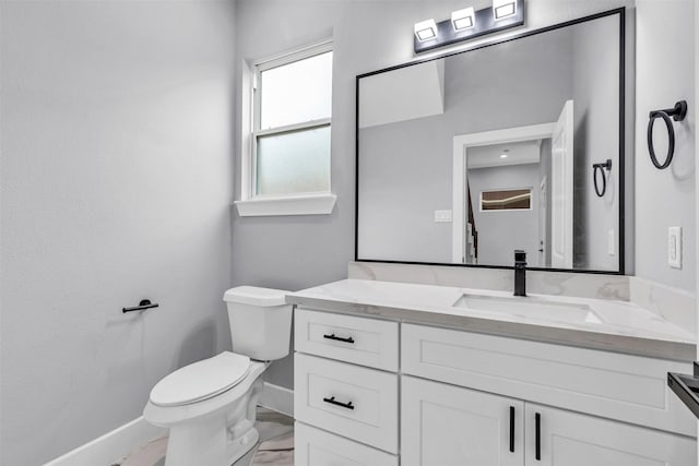 5029 Creekmont Dr, Houston, TX 77091 - half bathroom featuring baseboards, vanity, toilet, and marble finish flooring
