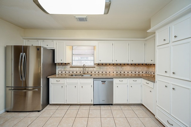 19515 Oak Timbers Dr, Humble, TX 77346 - kitchen with stainless steel appliances, a sink, and white cabinetry