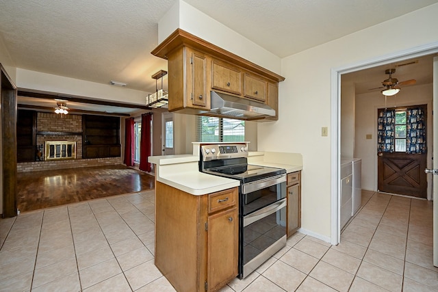 19515 Oak Timbers Dr, Humble, TX 77346 - kitchen featuring double oven range, under cabinet range hood, a ceiling fan, light tile patterned flooring, and light countertops