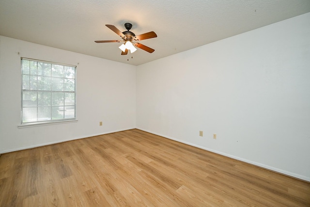 19515 Oak Timbers Dr, Humble, TX 77346 - spare room featuring light wood finished floors, baseboards, and a ceiling fan
