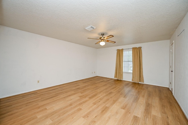 19515 Oak Timbers Dr, Humble, TX 77346 - empty room with light wood finished floors, a ceiling fan, a textured ceiling, and baseboards