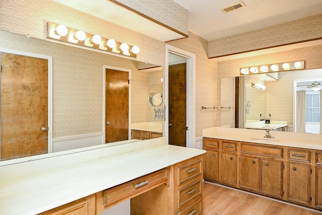 19515 Oak Timbers Dr, Humble, TX 77346 - bathroom featuring wood finished floors, vanity, wallpapered walls, and a wall unit AC