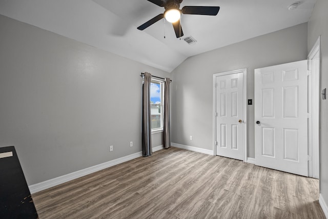 219 Rolling Springs Ln, Dickinson, TX 77539 - unfurnished bedroom featuring wood finished floors, vaulted ceiling, baseboards, and a ceiling fan