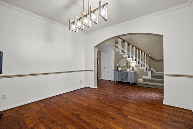 219 Rolling Springs Ln, Dickinson, TX 77539 - unfurnished room with ornamental molding, stairs, arched walkways, wood finished floors, and baseboards