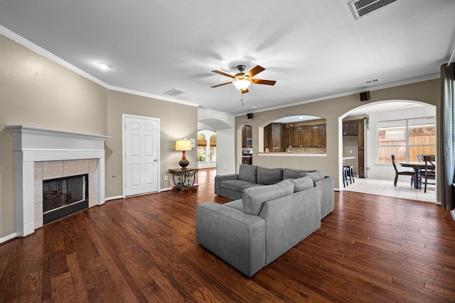 219 Rolling Springs Ln, Dickinson, TX 77539 - living room featuring ceiling fan, wood finished floors, crown molding, a fireplace, and baseboards