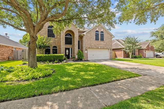 219 Rolling Springs Ln, Dickinson, TX 77539 - traditional-style house featuring driveway, a garage, and brick siding
