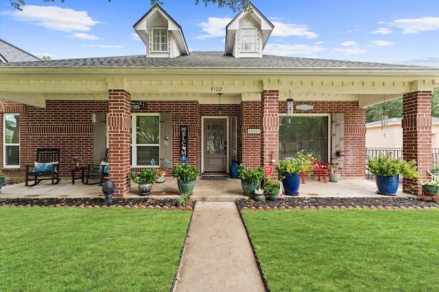 3102 E Elm Cir, Katy, TX 77493 - view of front facade with brick siding, a front lawn, a porch, and roof with shingles