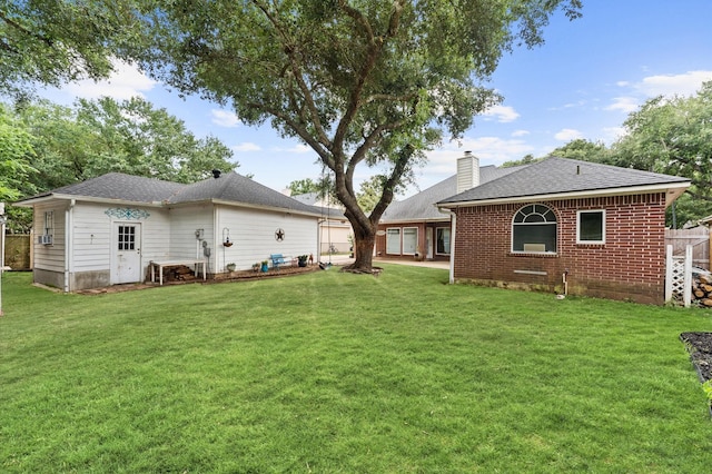 3102 E Elm Cir, Katy, TX 77493 - rear view of property with a chimney, brick siding, and roof with shingles