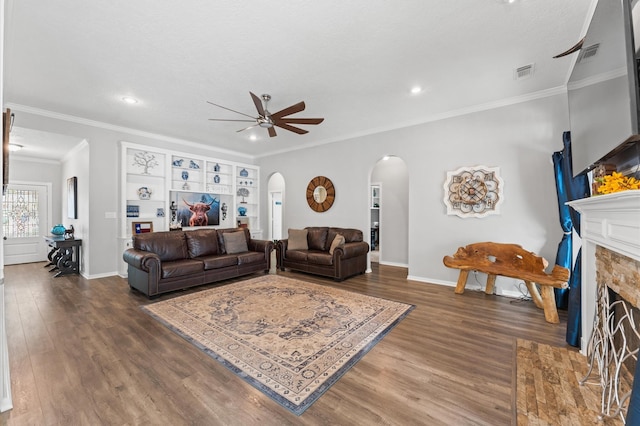 3102 E Elm Cir, Katy, TX 77493 - living area featuring arched walkways, ceiling fan, wood finished floors, a tiled fireplace, and recessed lighting