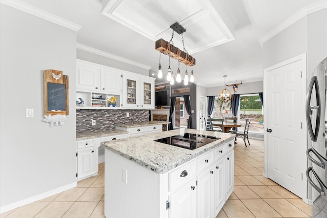 3102 E Elm Cir, Katy, TX 77493 - kitchen with black electric cooktop, light tile patterned floors, a kitchen island, tasteful backsplash, and crown molding