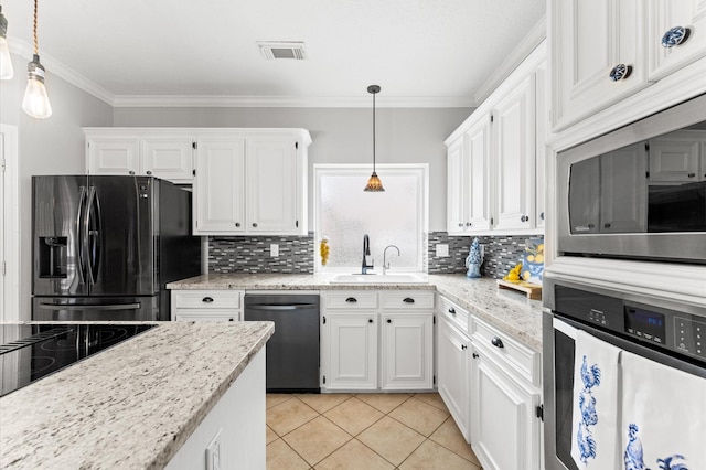 3102 E Elm Cir, Katy, TX 77493 - kitchen with stainless steel appliances, a sink, white cabinetry, crown molding, and decorative backsplash