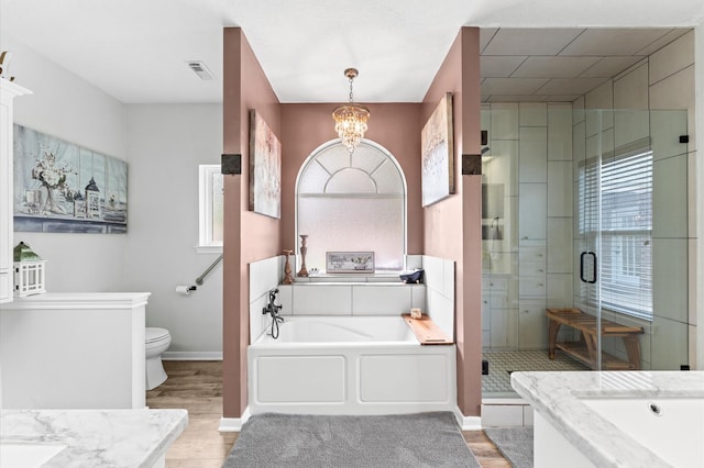 3102 E Elm Cir, Katy, TX 77493 - bathroom with a garden tub, wood finished floors, a stall shower, and toilet