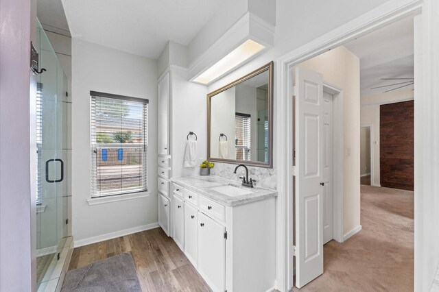 3102 E Elm Cir, Katy, TX 77493 - bathroom with vanity, a stall shower, wood finished floors, and baseboards