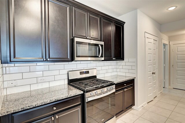 31702 Casa Linda Dr, Hockley, TX 77447 - kitchen with stainless steel appliances, light tile patterned floors, light stone counters, backsplash, and recessed lighting