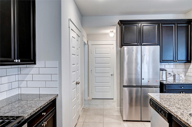 31702 Casa Linda Dr, Hockley, TX 77447 - kitchen with stainless steel appliances, light tile patterned flooring, light stone countertops, and tasteful backsplash