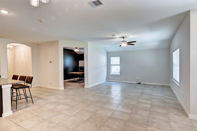 31702 Casa Linda Dr, Hockley, TX 77447 - living area with arched walkways, ceiling fan, and light tile patterned floors