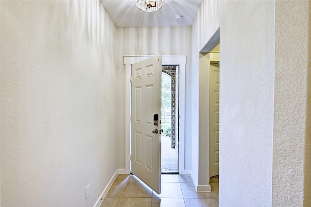 31702 Casa Linda Dr, Hockley, TX 77447 - entrance foyer featuring light tile patterned flooring, a chandelier, and a textured wall