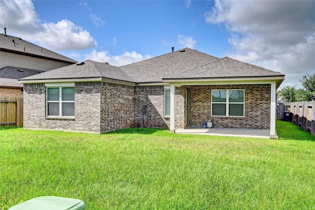 31702 Casa Linda Dr, Hockley, TX 77447 - back of house featuring a fenced backyard, brick siding, a patio, and a shingled roof